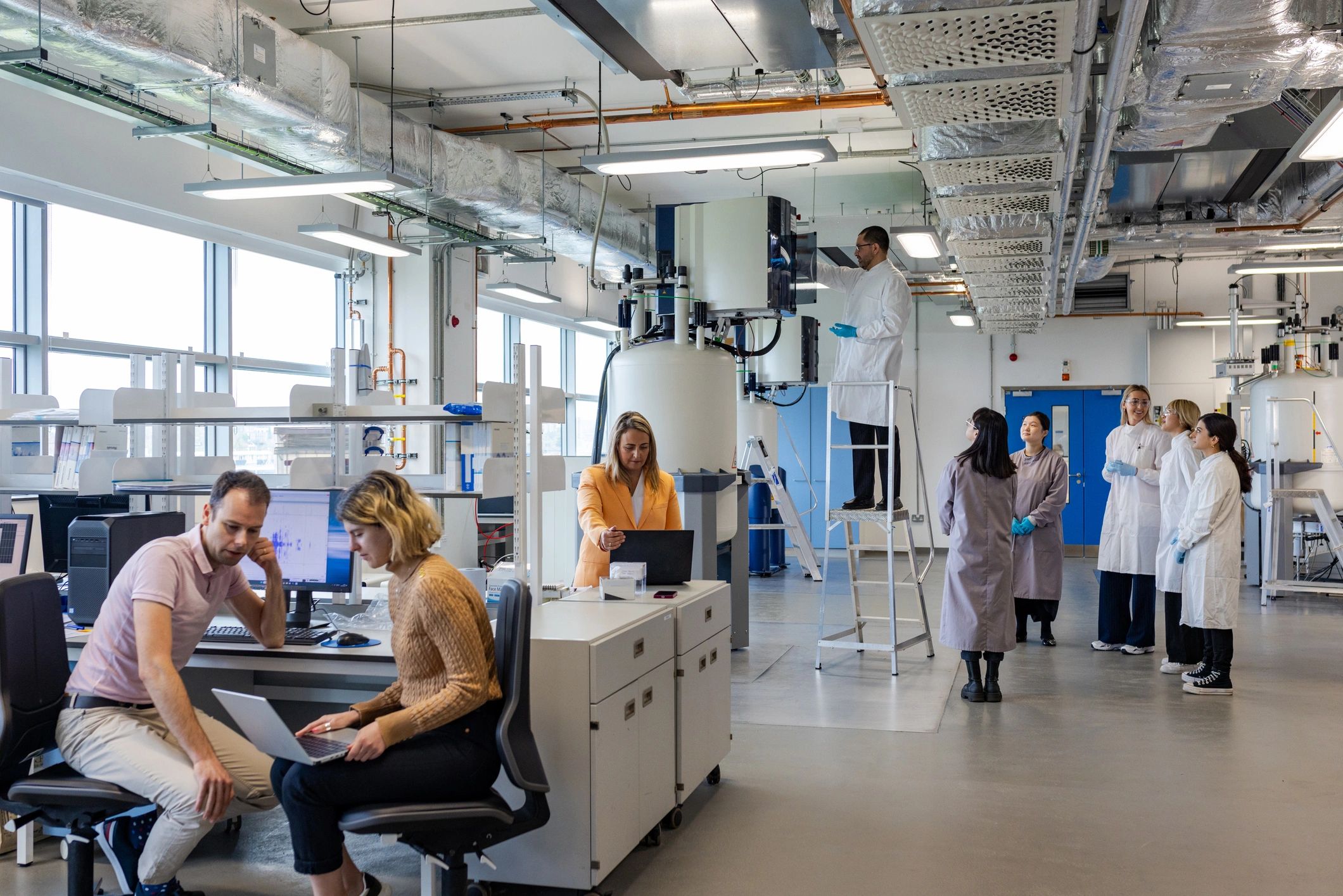 Research team reviewing peptide data in a laboratory